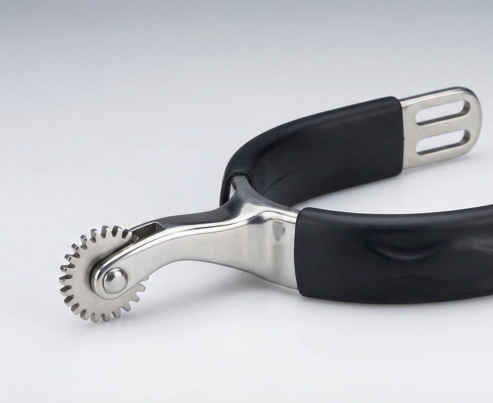 A professional cog rowel spur with a gear-shaped stainless steel wheel and a protective rubberized heel band.