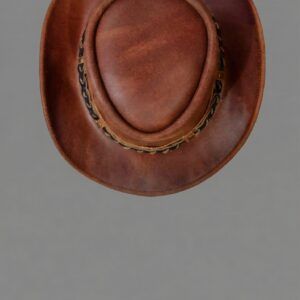 An overhead view of a cognac-outback hat showcasing rich brown tones and a braided band.