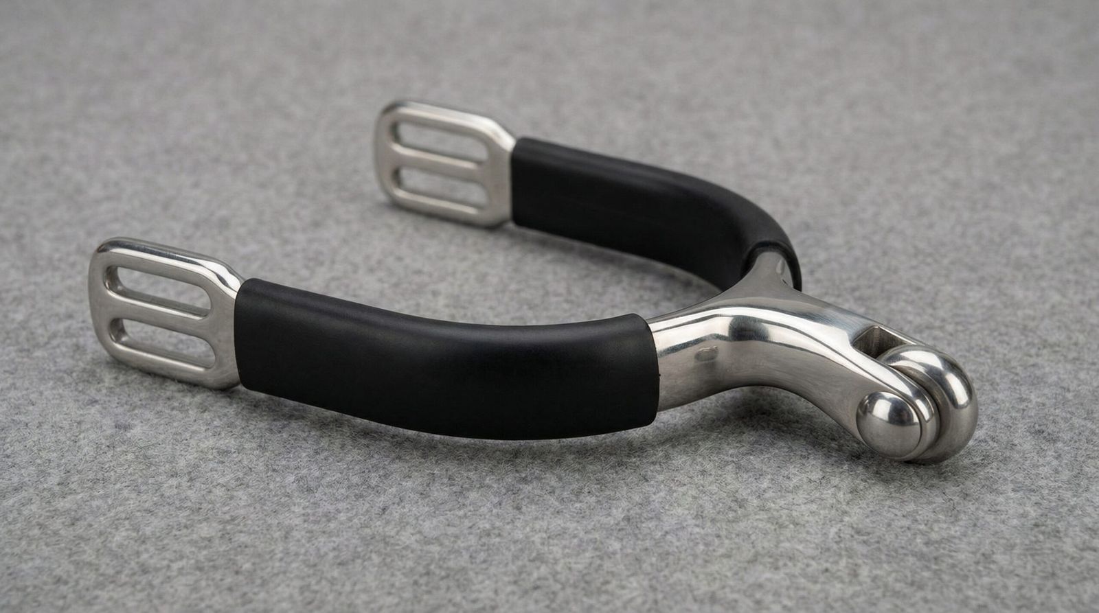 A professional roller ball spur featuring a smooth rotating ball mechanism and a protective black rubberized heel band.