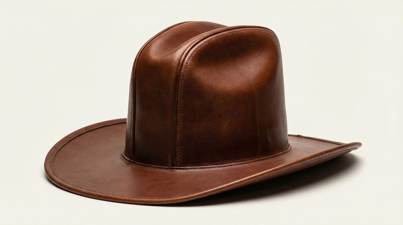A premium brown leather Sharp Ridge Cowboy Hat featuring a tall crown with severe creases and pronounced raised ridges.